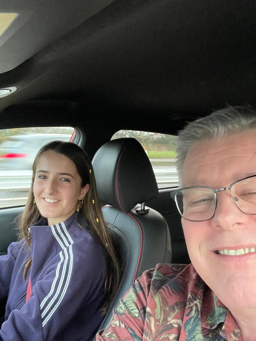 Ian Hallwood in the passenger seat during a driving lesson, with a smiling learner at the wheel